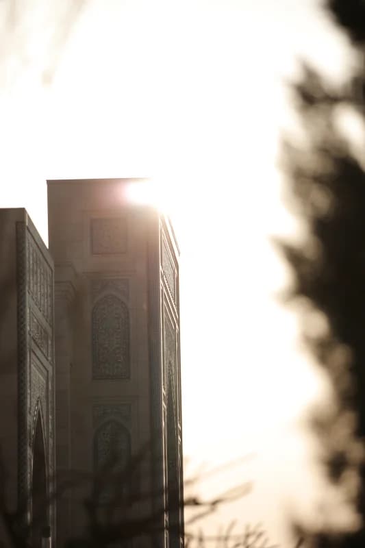 Sunlight behind traditional mosque facade