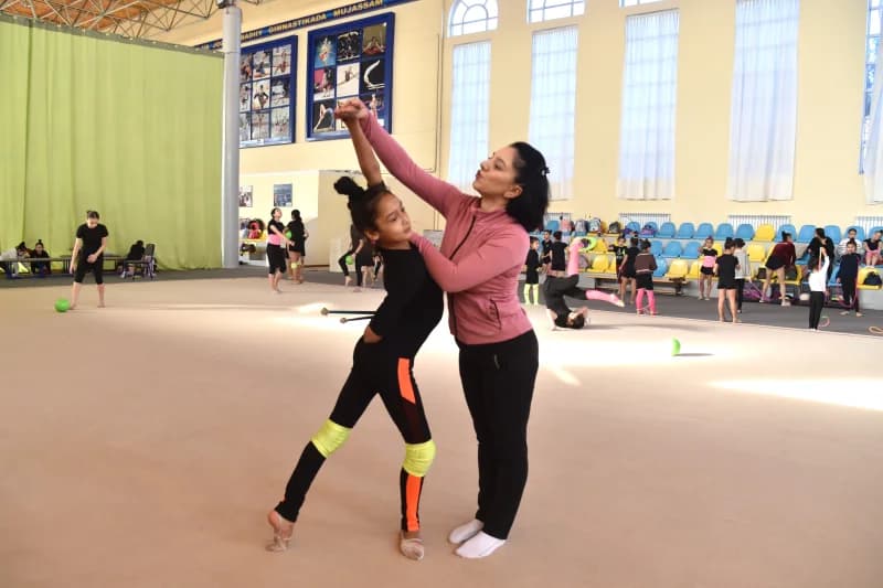 Gymnastics Coach Training Young Athlete