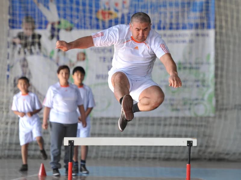 Athlete jumping over a hurdle