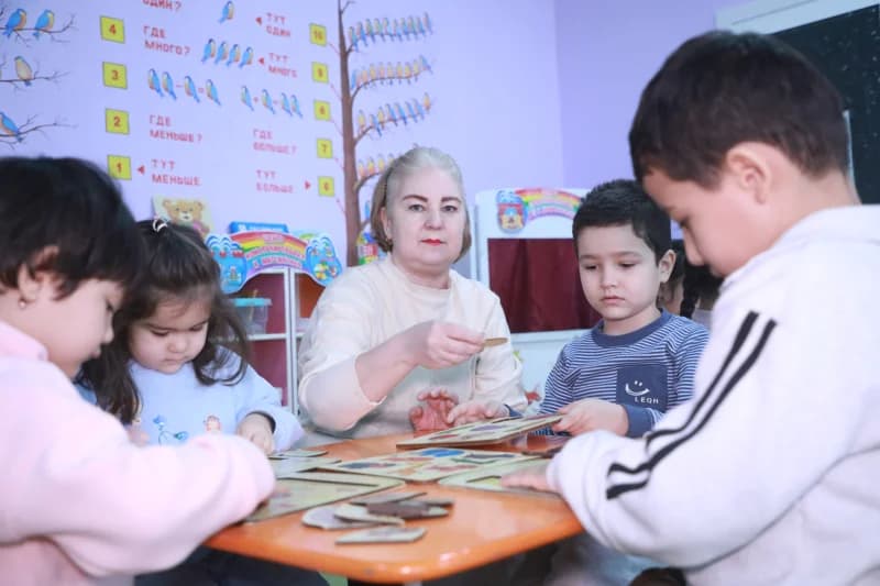 Teacher and children playing educational games