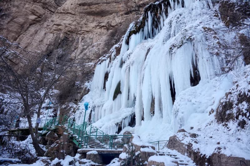 Frozen waterfall in winter mountain landscape