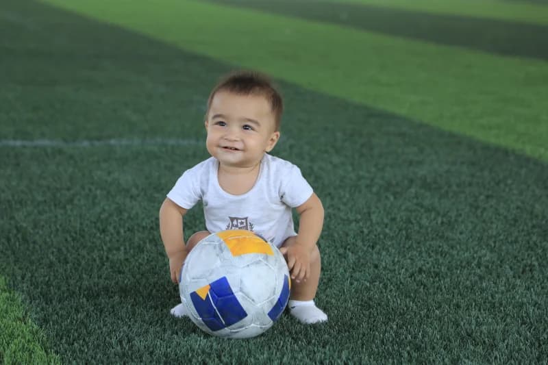 Toddler sitting with soccer ball