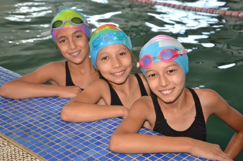 Young girls swimming in indoor pool