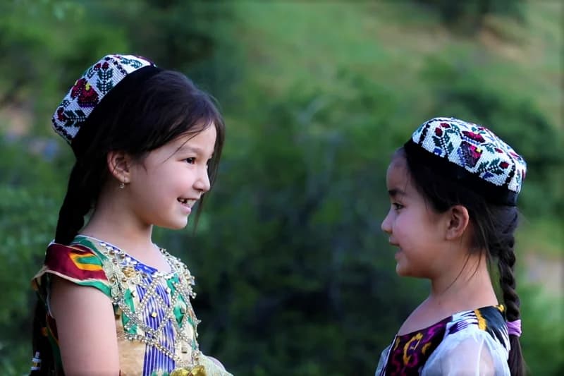 two girls wearing traditional caps