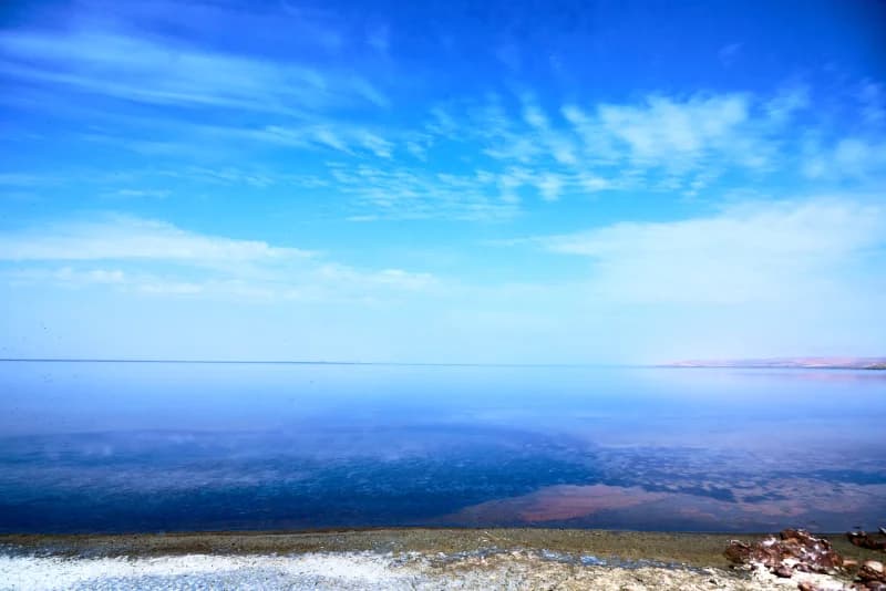 Sunlight reflects on calm lake