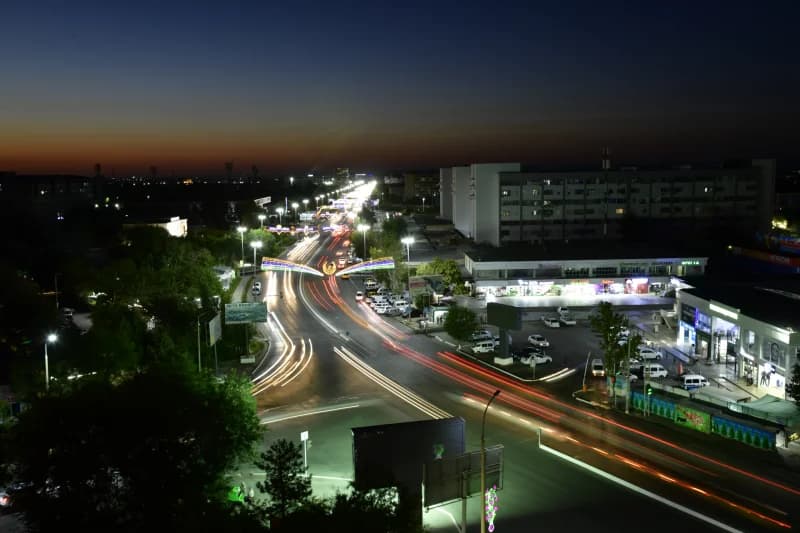 cars drive along city street