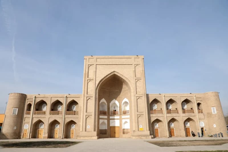 Sunlight illuminates historic brick madrasa