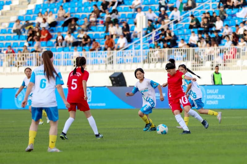 Young female athletes playing football