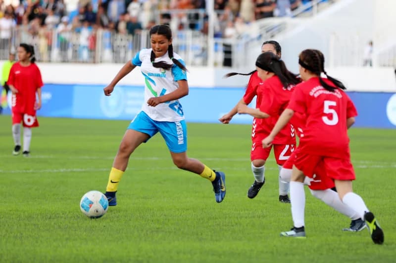 Young female athletes playing football
