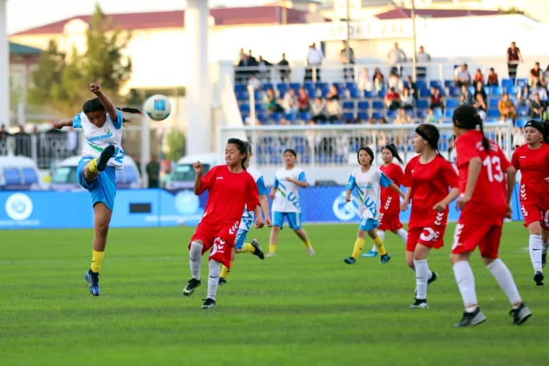young female athletes playing football