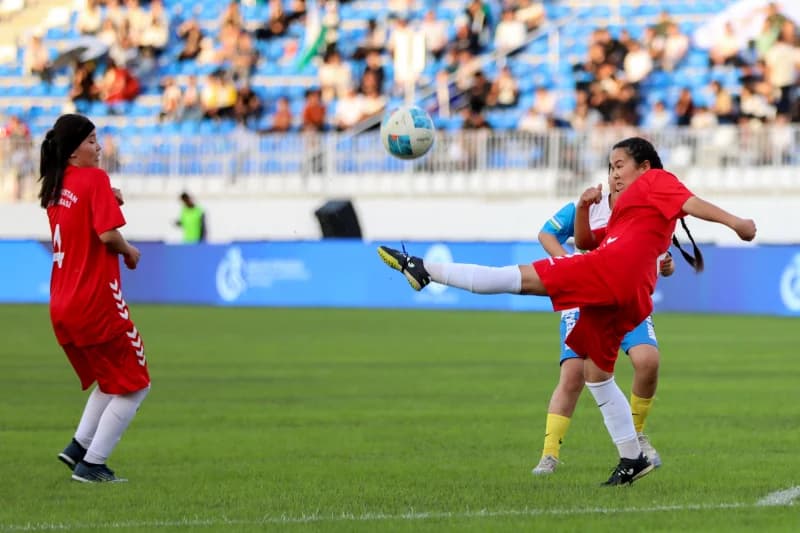 Female athletes playing football match