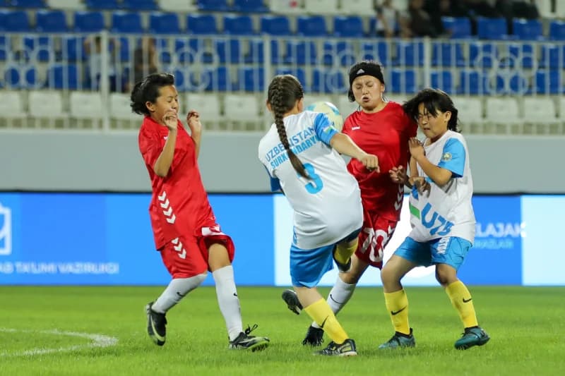 Young female athletes playing football