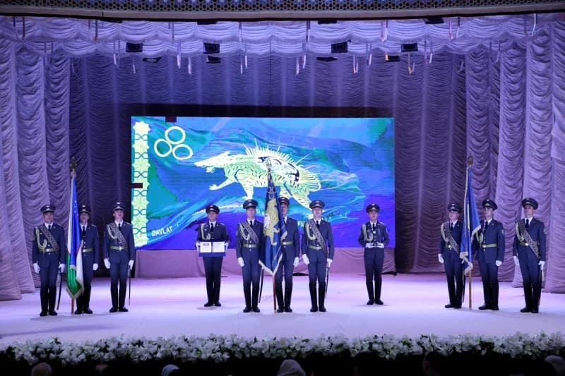 Honor guards stand on stage