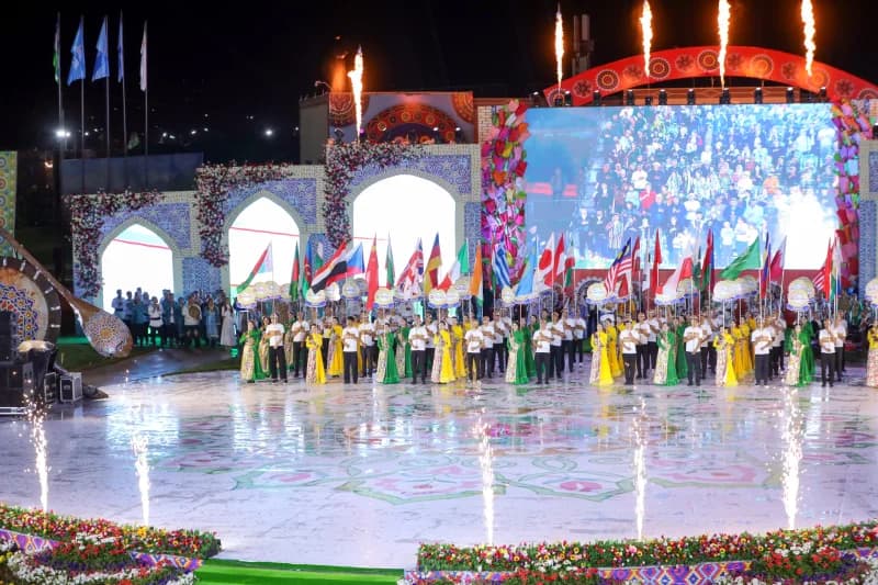 Participants carry flags during ceremony