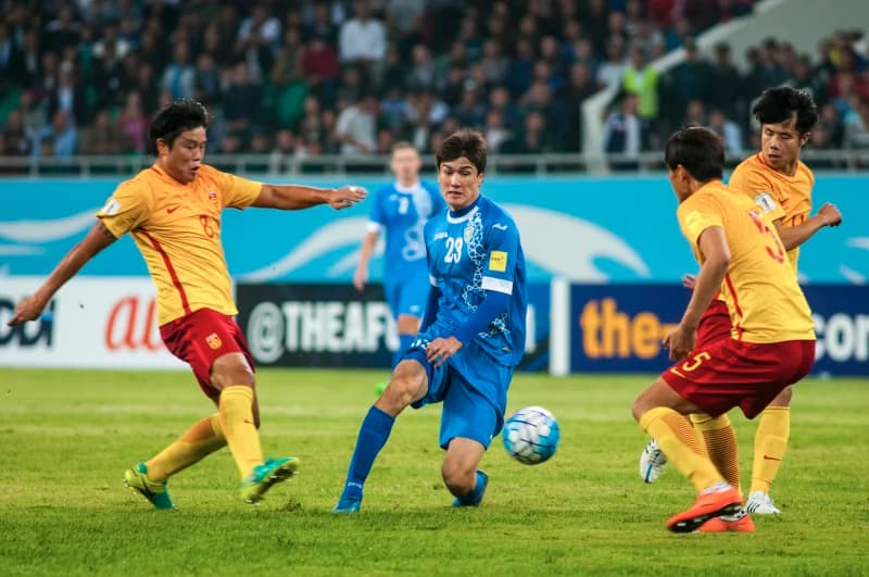 Players competing for soccer ball