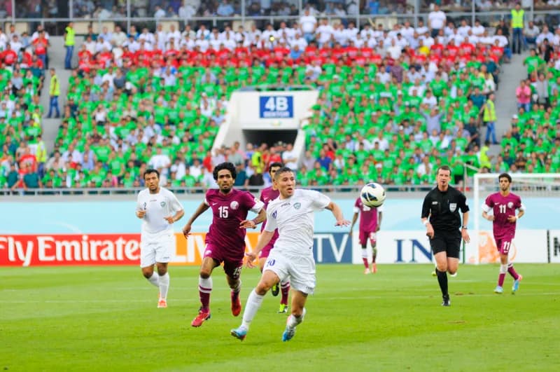 Players competing for soccer ball