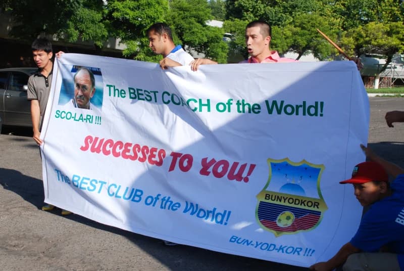Fans holding banner for coach