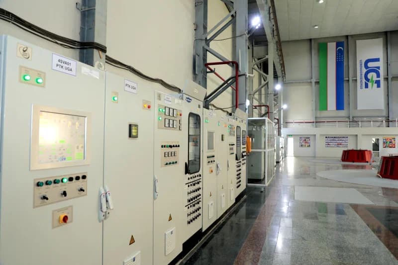 Technicians monitor industrial power control panels