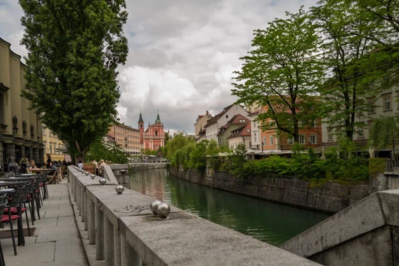 people relaxing by city canal
