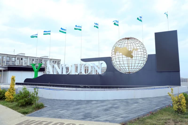 Flags fly over Andijan sign