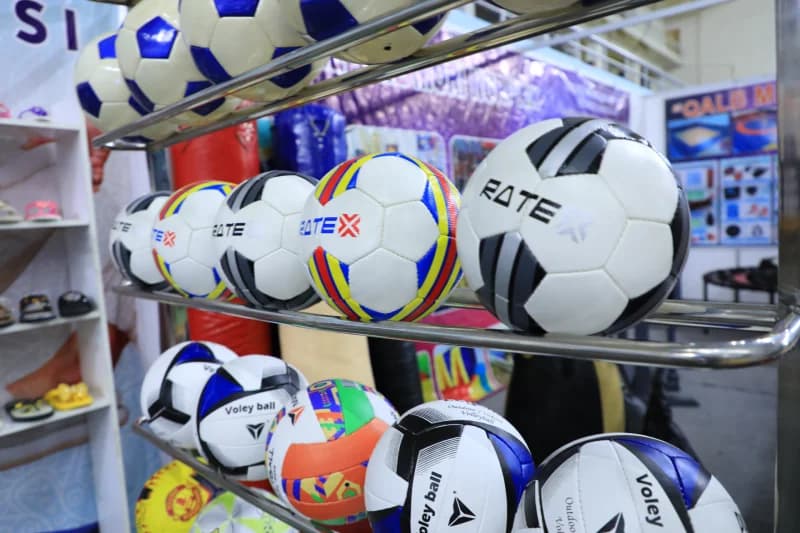 sports balls sit on shelves