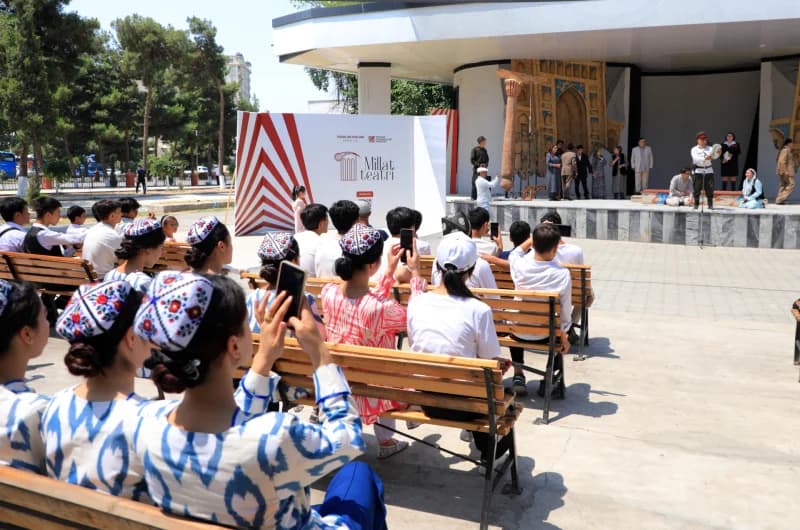 Audience watches outdoor theatrical performance