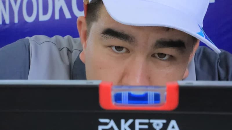 Worker checks level of surface