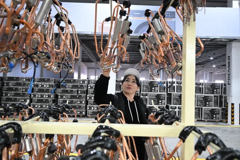 Worker inspecting copper cooling components