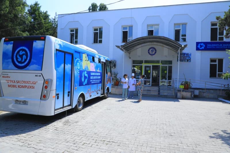 Medical staff stand near bus