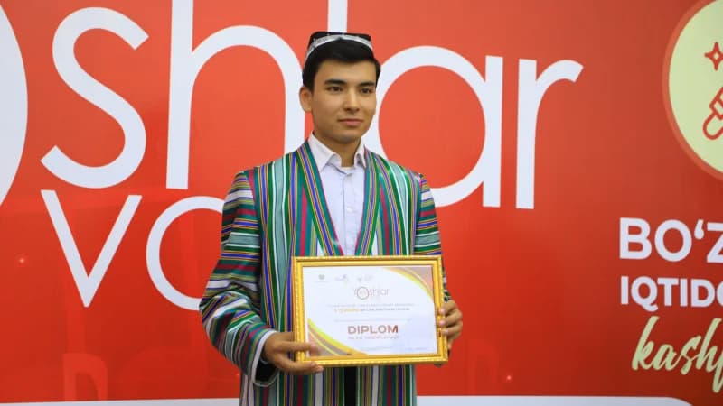 Young man holding achievement certificate