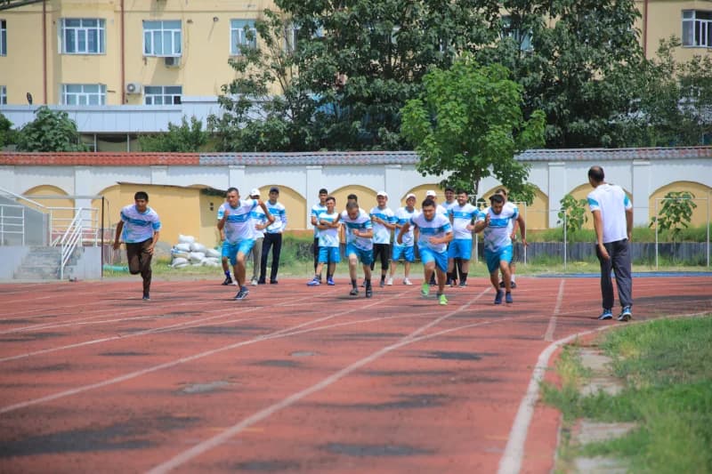 men compete in track running race
