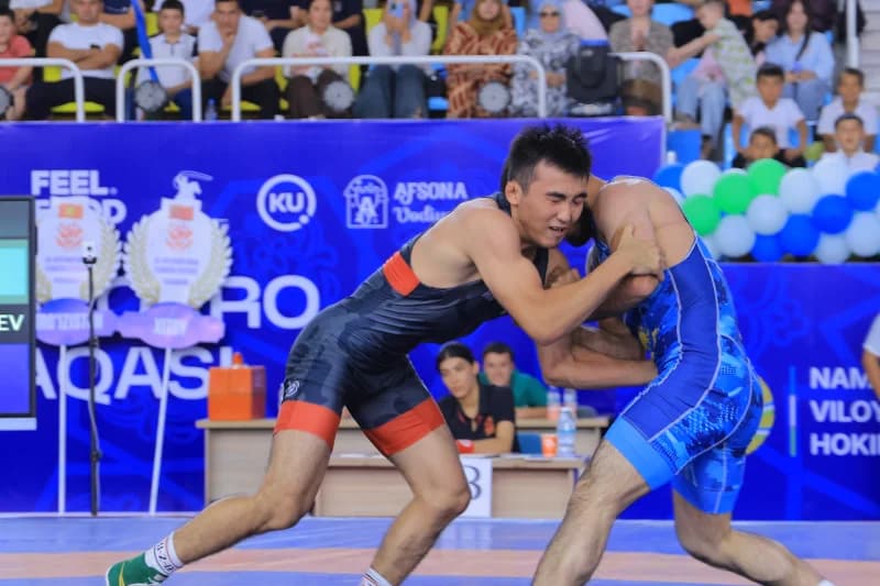Wrestlers compete on the mat