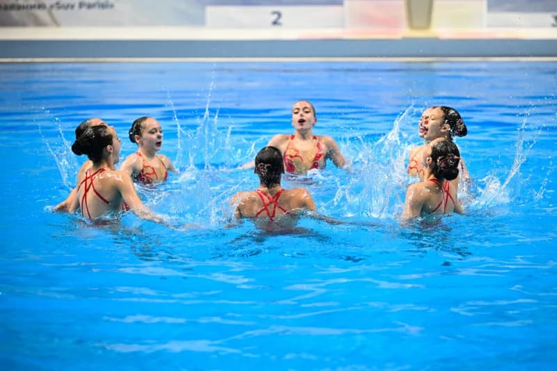 Спортсмены выполняют синхронное плавание