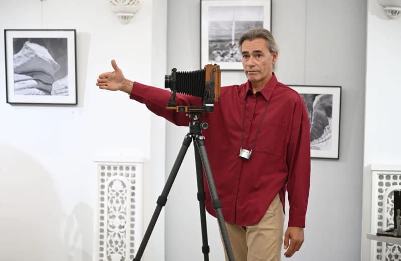 photographer presenting vintage camera equipment