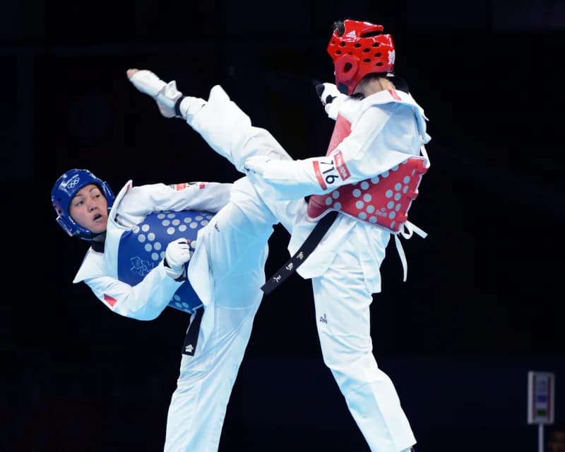 Two athletes competing in taekwondo