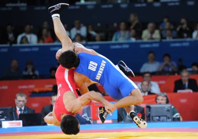 Wrestlers compete on the mat