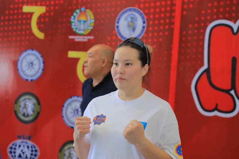 Female athlete holding clenched fists
