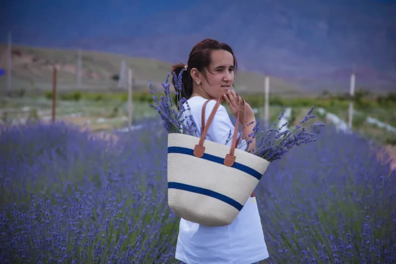 Young woman carrying lavender flowers
