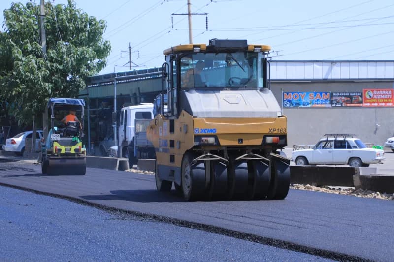 Road workers paving city street