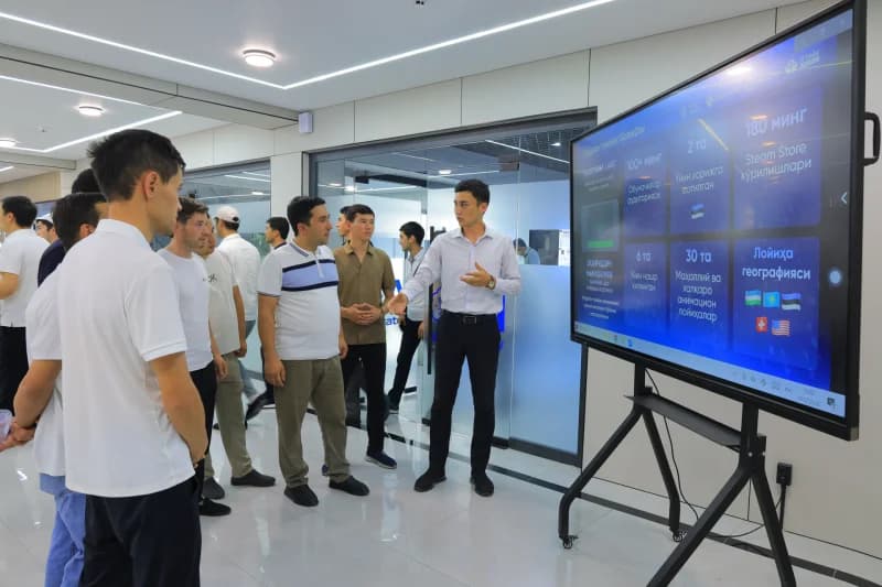 Young men attending technology presentation