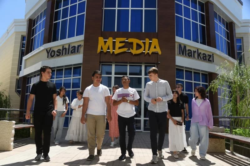 Young people walking outside building