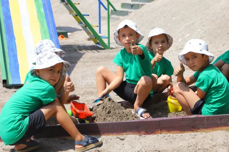 Children playing in outdoor sandbox