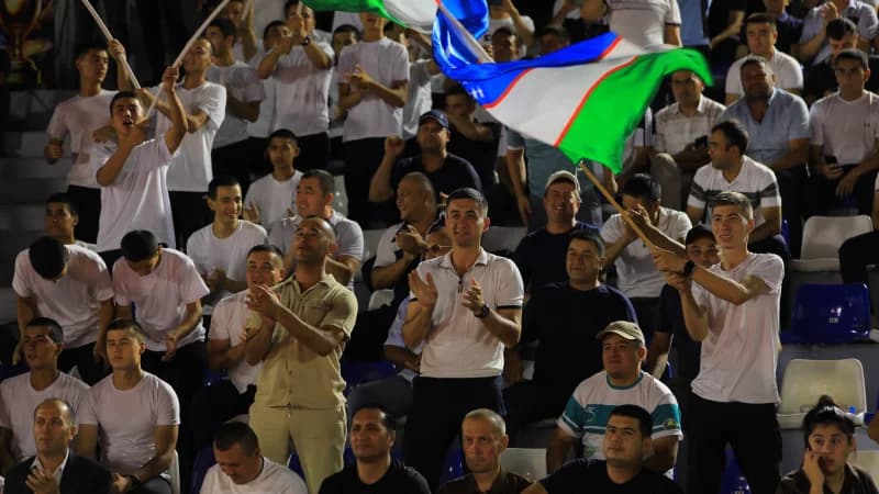 Spectators cheering at sports stadium