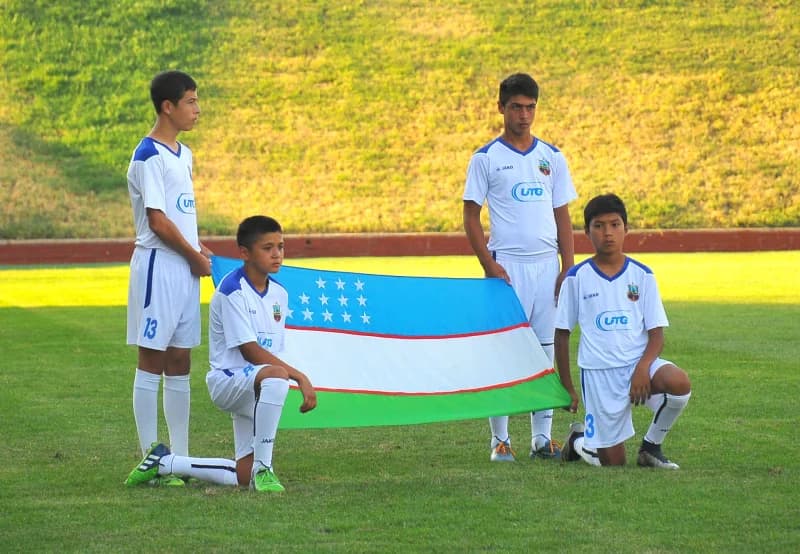 Young soccer players holding flag