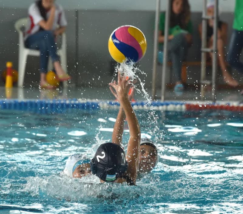 Water polo players compete intensely
