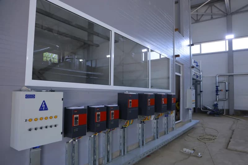 Technicians install industrial control panels