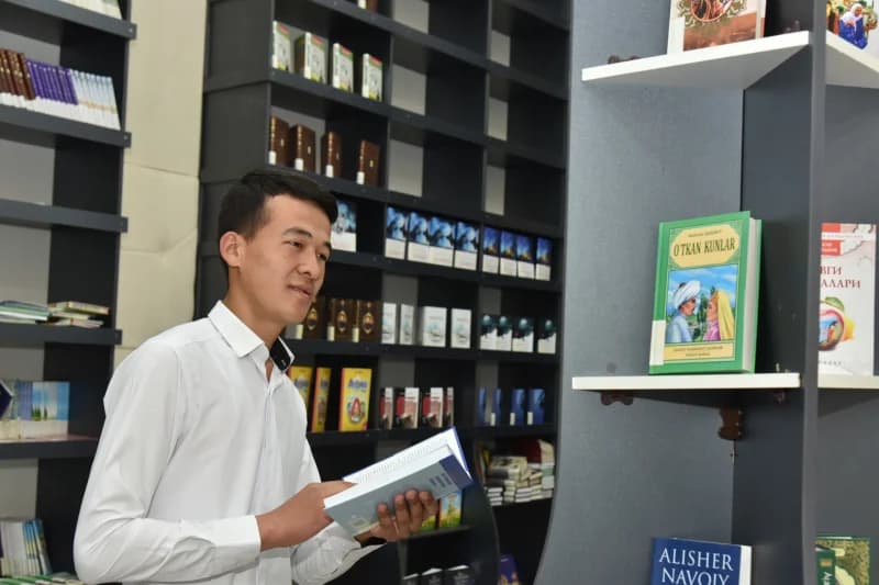 Young man reading in library