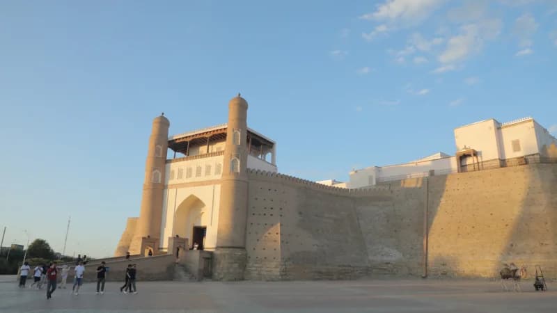 Visitors exploring ancient fortress architecture