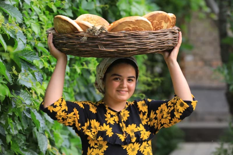 Young woman carrying bread basket