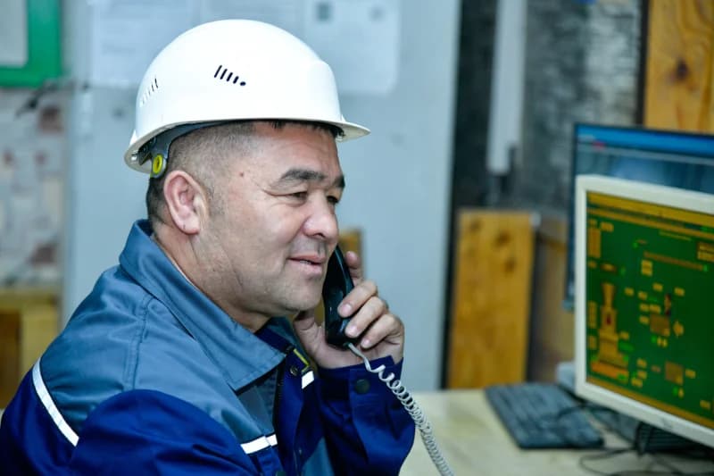 Worker talking on office telephone